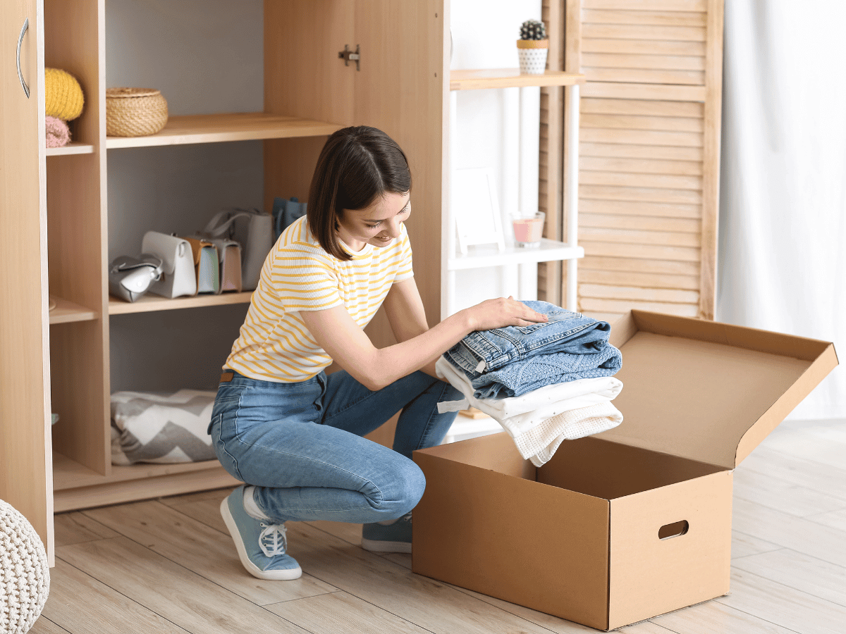 woman organizing closet for cold weather season