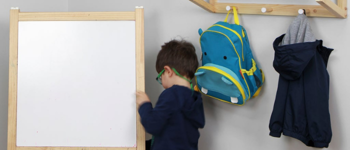 hooks hanging on wall in kids room to provide additional storage solutions