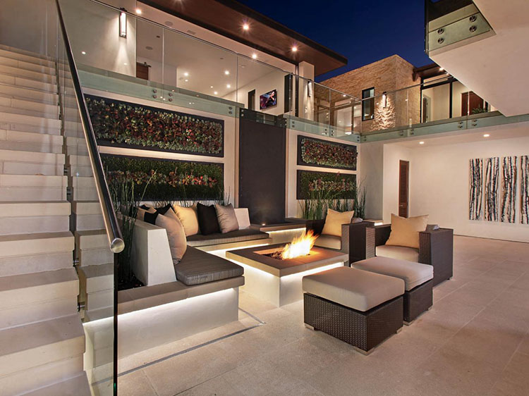 beautiful fireplace in the middle of an indoor outdoor living space