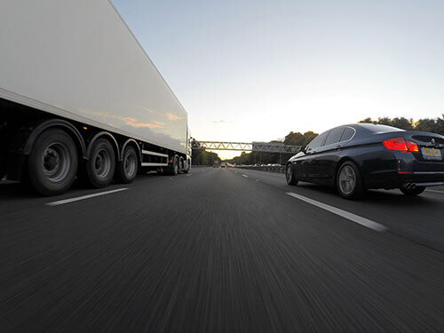 Truck and car on the highway for a long distance move